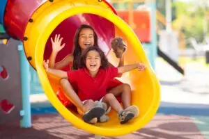 Kids going down a slide. 